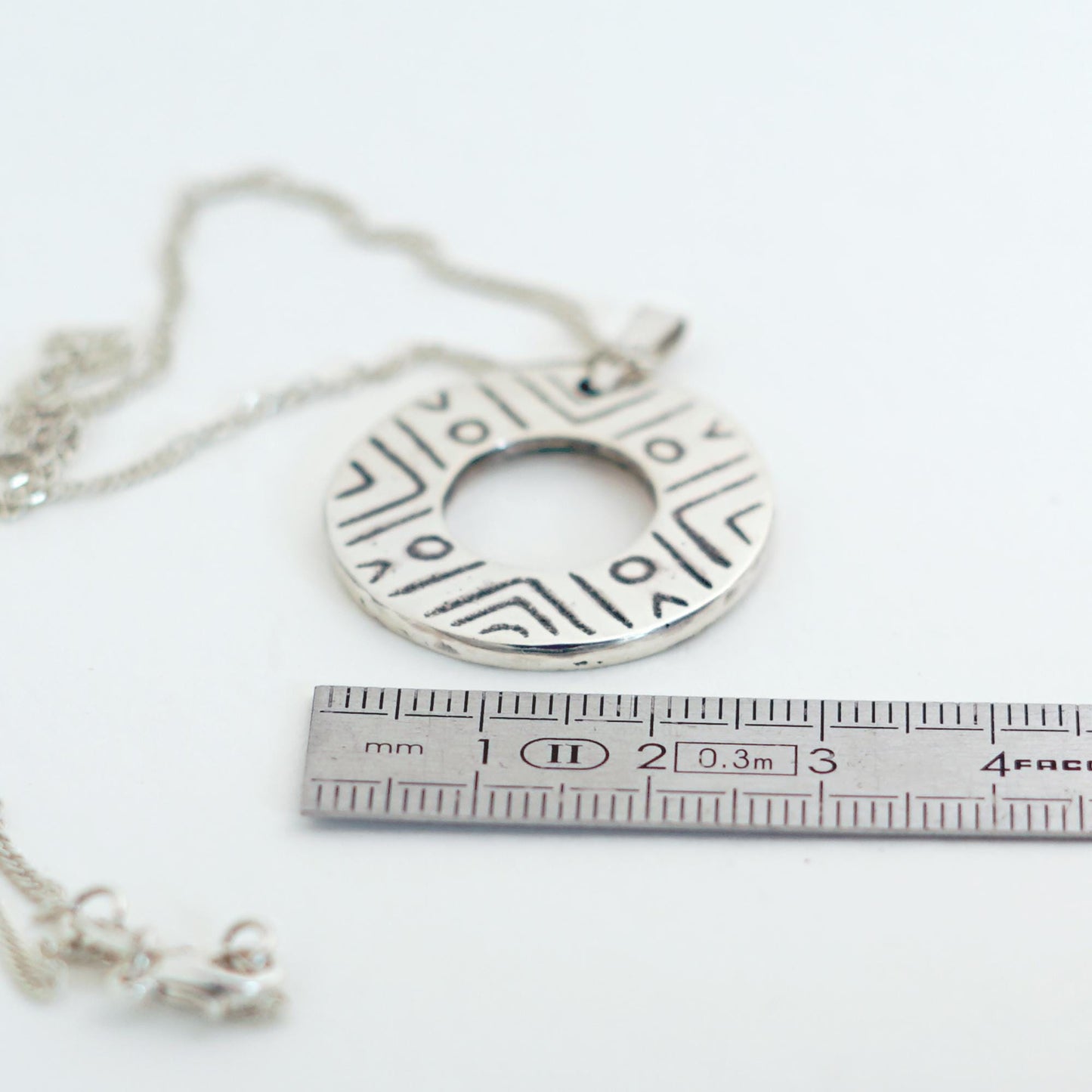 Sterling Silver donut shaped pendant with geometric pattern | Handmade circle necklace with ethnic design